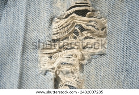 worn ripped jeans closeup. faded jeans background