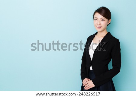 asian businesswoman isolated on blue background Royalty-Free Stock Photo #248226517