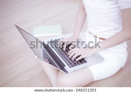 Asian woman using laptop at home