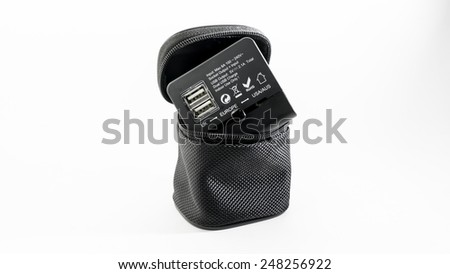 Black colour universal power plug adapter with dual usb port in a pouch for traveller in UK, Europe and USA or Australia. Isolated on white background.