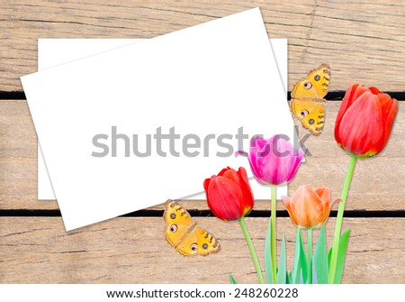card on wood boards and tulips flowers and butterfly 