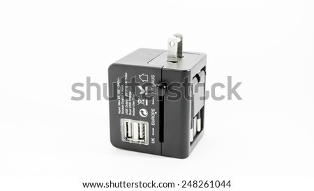 Compact and modern black colour universal electrical outlet plugs or plug adapter with multiple plug points for traveller in UK, Europe and USA or Australia. Isolated on white background.