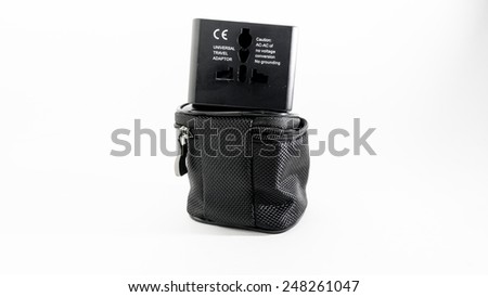 Black colour universal power plug adapter with dual usb port in a pouch for traveller in UK, Europe and USA or Australia. Isolated on white background.