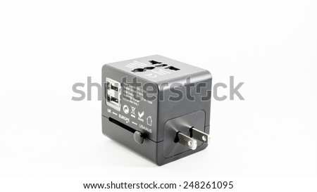 Compact and modern black colour universal electrical outlet plugs or plug adapter with multiple plug points for traveller in UK, Europe and USA or Australia. Isolated on white background.