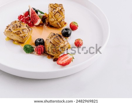 Gourmet french toast with fresh berries and fruit coulis on a pristine white background