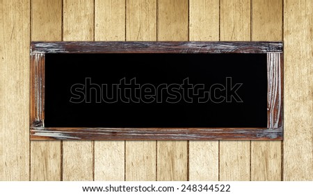 Empty vintage chalk board on wood wall background, wording template