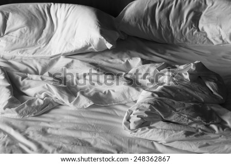 Messy white bed and two pillow, in the morning  Royalty-Free Stock Photo #248362867