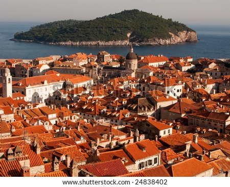 This is a picture ot Dubrovnik red and orange roofs and distant island behind.