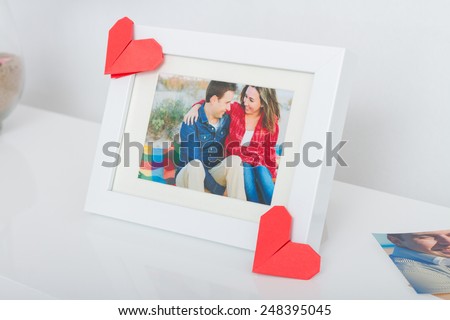 Decoration for Valentine's day. Frame with couple photo and origami hearts