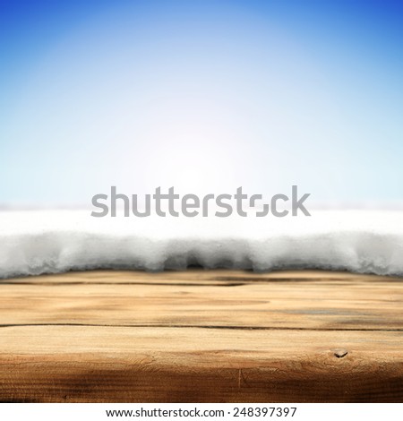 big wooden desk space and ice and sky of blue background 