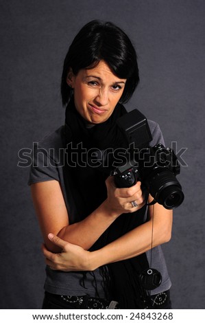Young woman photographer holding a photo camera