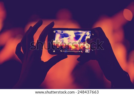 phone in the hands of women on the show Royalty-Free Stock Photo #248437663