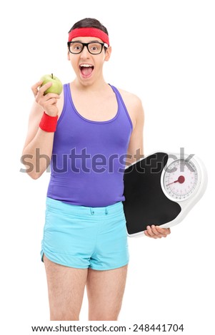 Nerdy guy eating apple and holding a weight scale isolated on white background