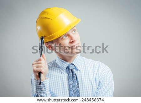 Young builder with adjustable wrench in hand 