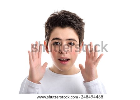 Funny Caucasian smooth-skinned boy in a white long sleeved t-shirt waving open hands along the sides of the face