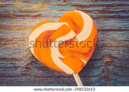 Heart lollipop candy on wood background - Vintage effect style pictures