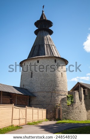 Classical Russian ancient architecture. Stone tower with wooden roofs of old fortress. Kremlin of Pskov, Russia