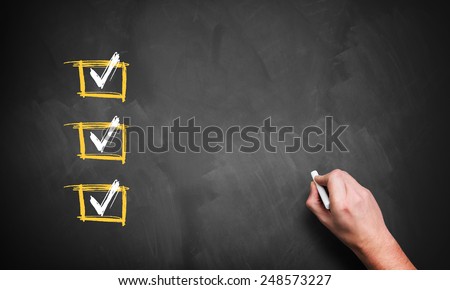 blackboard with 3 checked rows and a hand with chalk, ready for customization with own checklist items Royalty-Free Stock Photo #248573227