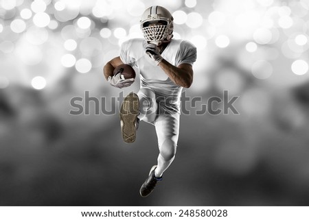 Football Player with a white uniform Running on a white lights background.