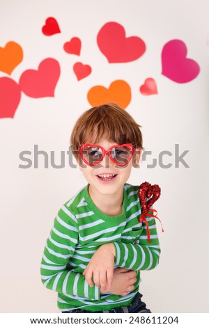 Valentine's Day arts, crafts and fun: hearts, heart-shaped glasses and toys, kids having fun, celebrate or party theme