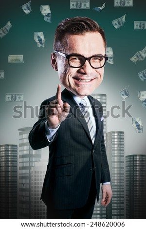 excited happy businessman with big head standing under dollar's rain and looking up. funny picture over dark background