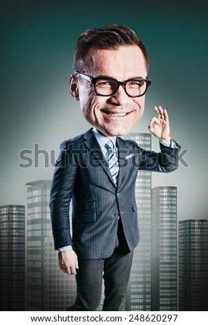excited happy businessman with big head showing thumbs up sign ok and looking up. funny picture over dark background