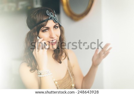Flapper girl talking on a smartphone similar to iphon, contrast concept