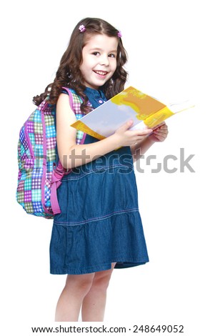 Happy little schoolgirl with backpack reading a book.Isolated on white background, Lotus Children's Center