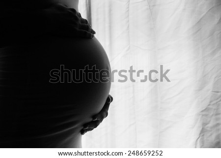 a silhouette of a pregnant woman on a white background