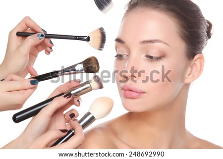 Closeup portrait picture of beautiful woman with brushes, isolated