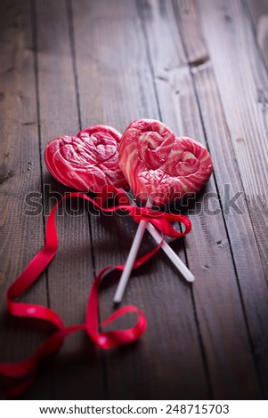 Lollipop hearts  on dark  wooden background.  Selective focus. Valentine Day background.