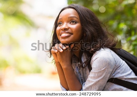 attractive female african college student daydreaming Royalty-Free Stock Photo #248729095