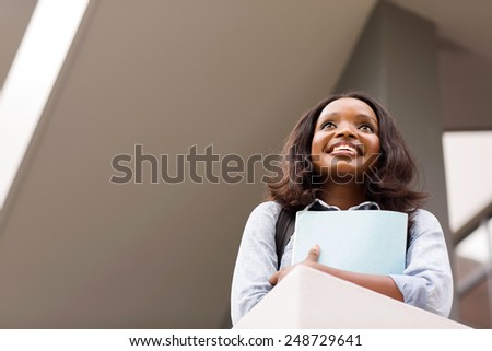 beautiful african female college student looking up