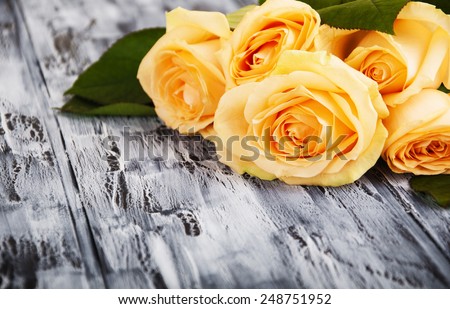 Beautiful roses on wooden dark background