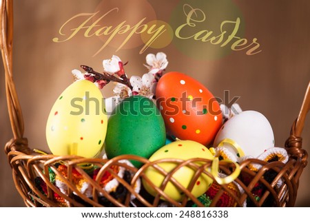 Easter motif, painted Easter eggs in a wooden box. decorated with a branch of white spring branch 