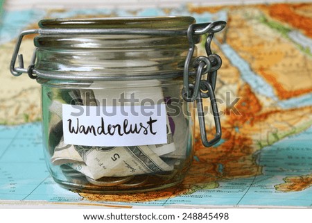 Wanderlust travel jar - vacation savings Royalty-Free Stock Photo #248845498