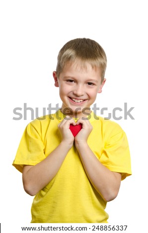 Boy holding small red heart symbol love in hands