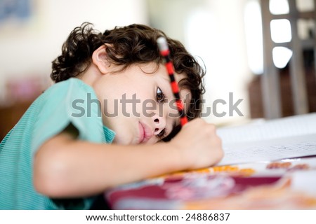 Young boy doing his homework at home.