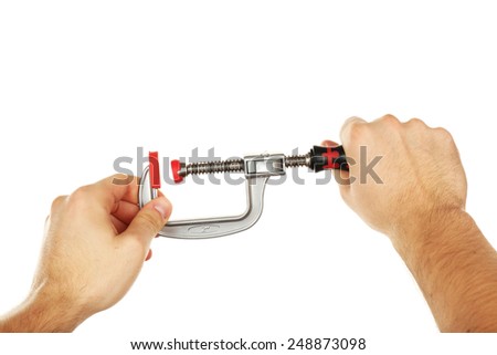 Clamp tool in male hand isolated on white