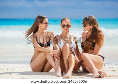 girl and two guys at the beach