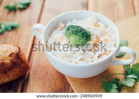 Trout With Rice And Broccoli On A Wooden Board