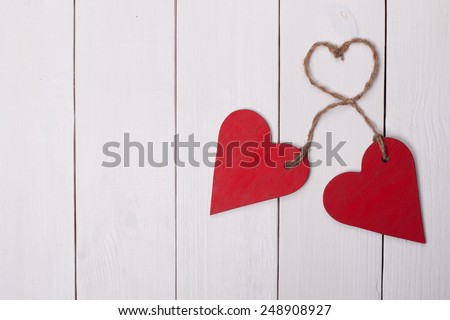 Two red hearts on a white wooden background. Valentine Day