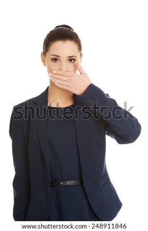 Portrait of young businesswoman covering with hand her mouth