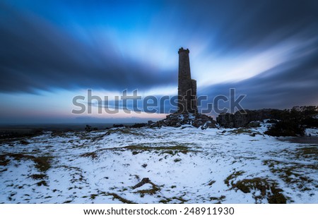A long exposure of a ruined chimney stack under a dramatic night sky on Bodmin Moor in Cornwall