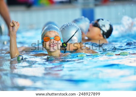 happy children kids group at swimming pool class learning to swim Royalty-Free Stock Photo #248927899