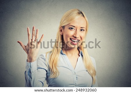 Closeup portrait, young excited woman, making five times sign gesture with hand fingers, isolated grey wall background. Positive human emotion facial expression feeling, attitude, symbol body language