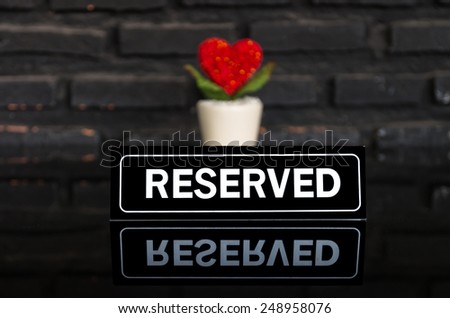 reserved signboard with heart on the table