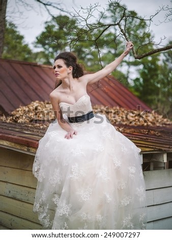 Bride staring out sitting on roof top waiting for her love/groom