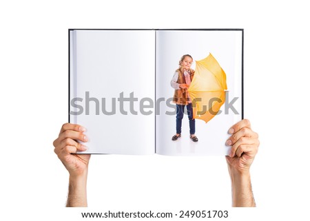 Blonde little girl holding an umbrella