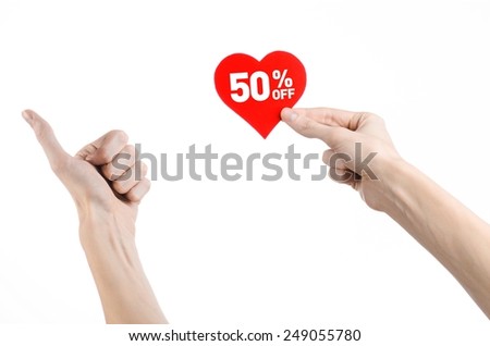 Valentine's Day discounts topic: Hand holding a card in the form of a red heart with a discount of 50% on an isolated white background in studio